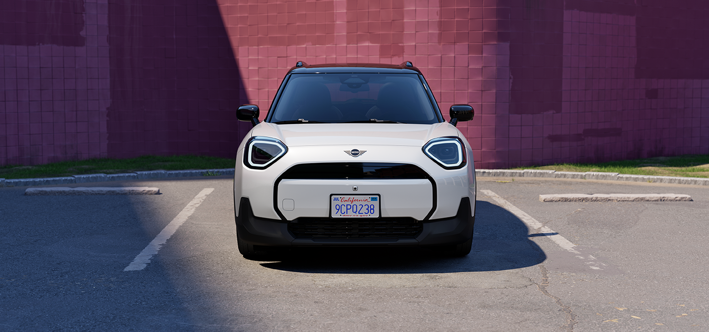 Front view of a MINI Countryman in Nanuq White Metallic parked in a marked parking space.