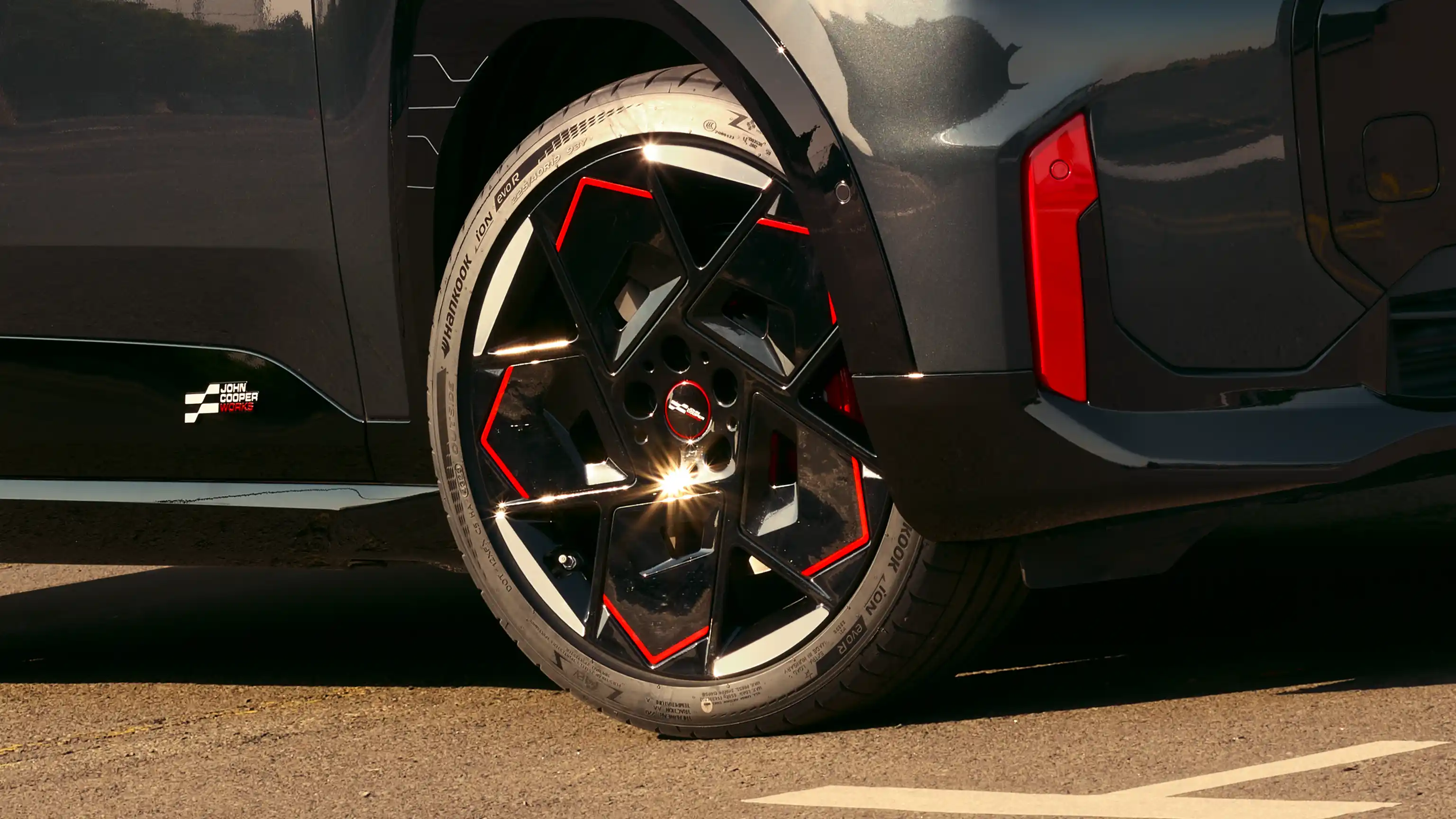 Close-up of a MINI John Cooper Works alloy wheel with black and red detailing.